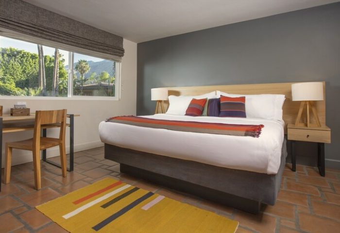 Santiago Resort, Palm Springs gay men's premier resort: guest room with king bed, desk, and view. Gay-friendly hotel interior.