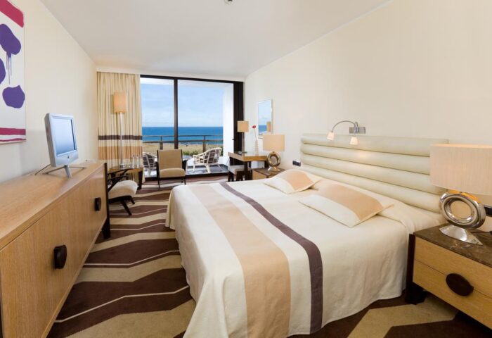 Seaside Palm Beach gay-friendly hotel room. King bed, balcony with ocean view. Upscale travel for gay men. Relaxing vacation.