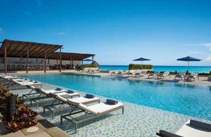 Secrets The Vine Cancun Resort & Spa pool. All-inclusive, adults-only, gay-friendly hotel with ocean view and lounge chairs.