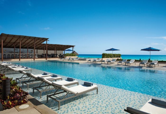 Secrets The Vine Cancun Resort & Spa pool. All-inclusive, adults-only, gay-friendly hotel with ocean view and lounge chairs.