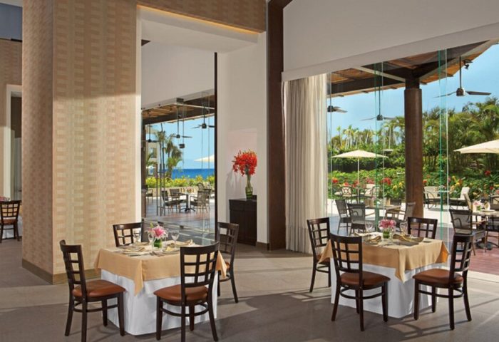 Secrets Vallarta Bay Resort All-Inclusive Adults-only restaurant. Tables set, ocean view. Gay-friendly hotel dining.