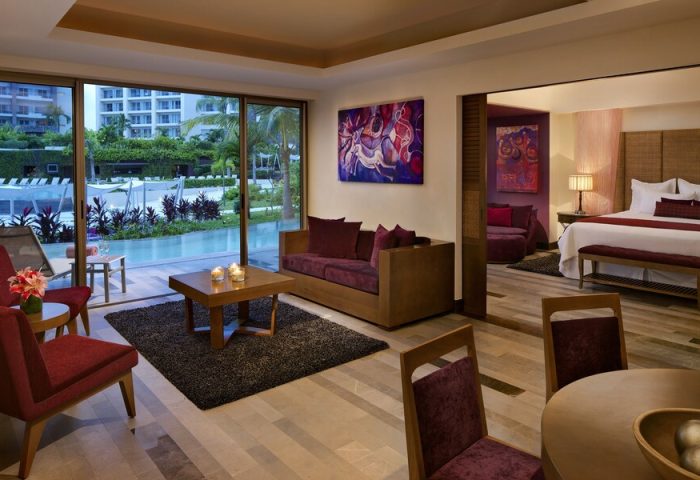 Secrets Vallarta Bay Resort suite. All-inclusive adults-only gay-friendly hotel room with living area, bedroom, and pool view.