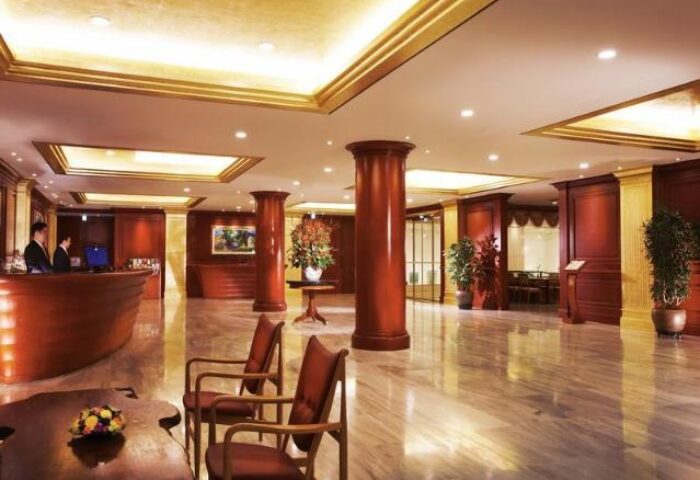 Sejong Hotel Seoul Myeongdong lobby. This gay-friendly hotel features a luxurious interior with marble floors and wood accents.