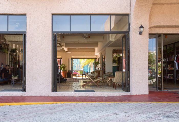 Selina Cancun Laguna Hotel Zone's entrance. Gay-friendly hotel with open doors to a stylish lobby. Inviting space for LGBTQ+ travelers.