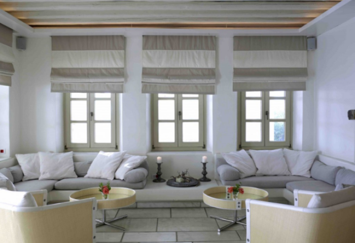 Semeli Hotel Mykonos lounge area. Gay-friendly hotel with stylish seating, natural light, and minimalist design. Perfect for gay men's travel.