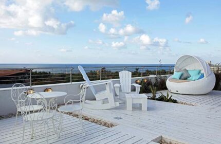 Shalom Hotel & Relax, an Atlas Boutique Hotel rooftop terrace. Gay-friendly, pet-friendly hotel with ocean view, white furniture.
