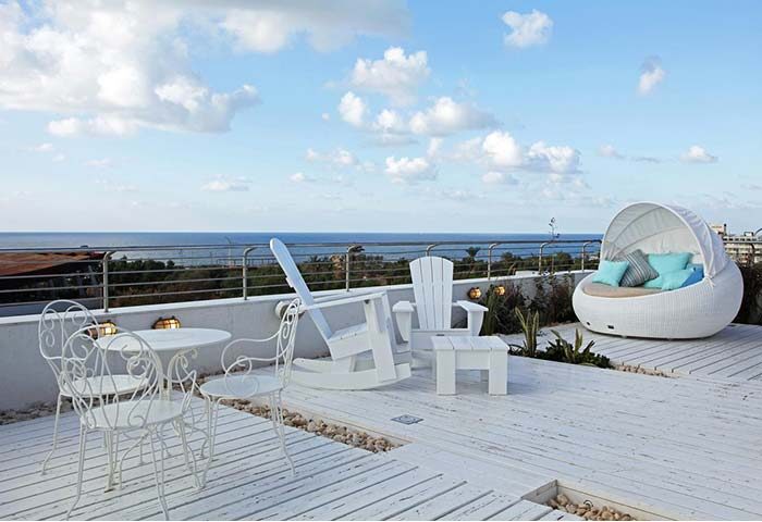 Shalom Hotel & Relax, an Atlas Boutique Hotel rooftop terrace. Gay-friendly, pet-friendly hotel with ocean view, white furniture.