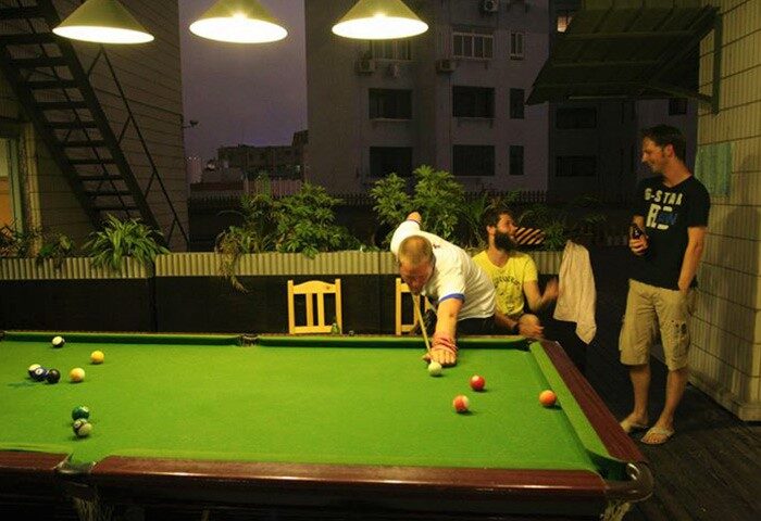 Shanghai Blue Mountain Youth Hostel Luwan: Gay travelers play pool at this gay-friendly hotel. A fun place to stay in Shanghai, China.