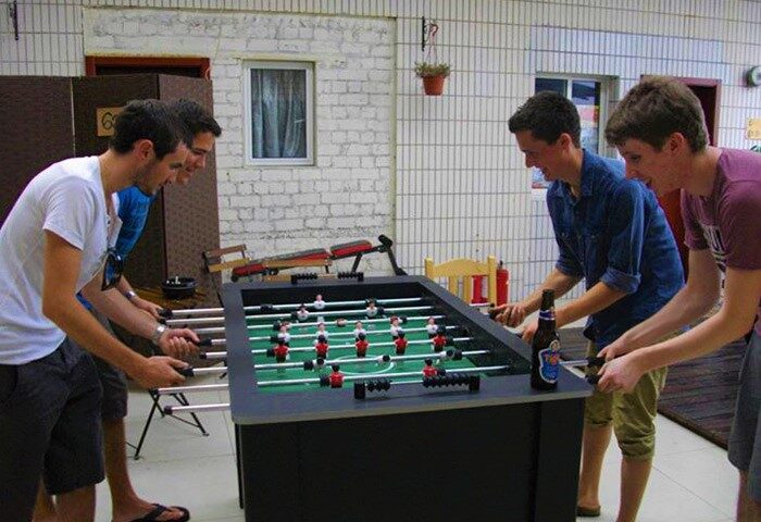 Gay-friendly Shanghai Blue Mountain Youth Hostel Luwan: guests play foosball. A fun way to meet other travelers at this Shanghai hostel.