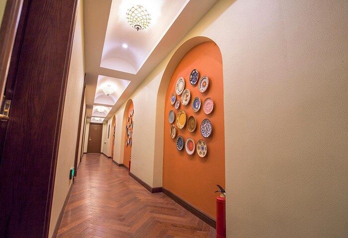 Hallway view, Shanghai Soho Garden Hotel. Plates decorate orange alcoves. A gay-friendly hotel in Shanghai for gay travelers.
