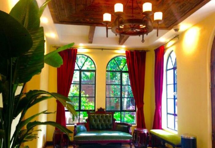 Shanghai Soho Garden Hotel interior. Gay-friendly hotel with vintage decor, red curtains, and garden views. A comfy, stylish stay in Shanghai.