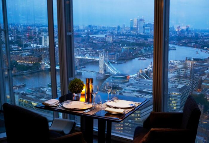 Romantic dinner at Shangri-La Hotel At The Shard, a gay-friendly hotel. London skyline view with Tower Bridge. Perfect for gay travelers.
