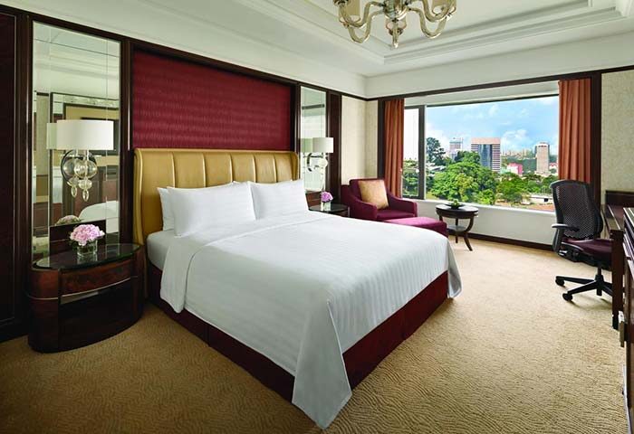 Gay-friendly Shangri La Hotel Kuala Lumpur room. Luxurious interior, large bed, city view. Ideal for gay travelers seeking comfort & style.