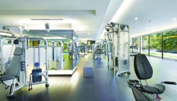 Gay-friendly Shangri-La Hotel Kuala Lumpur gym. Modern fitness center with weight machines, cardio equipment, and natural light.