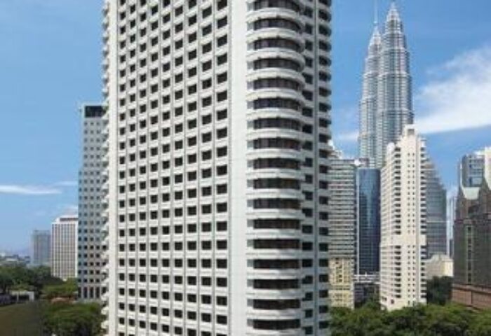 Shangri-La Hotel Kuala Lumpur, a gay-friendly hotel. Exterior view of the high-rise building with the Petronas Towers in the background.