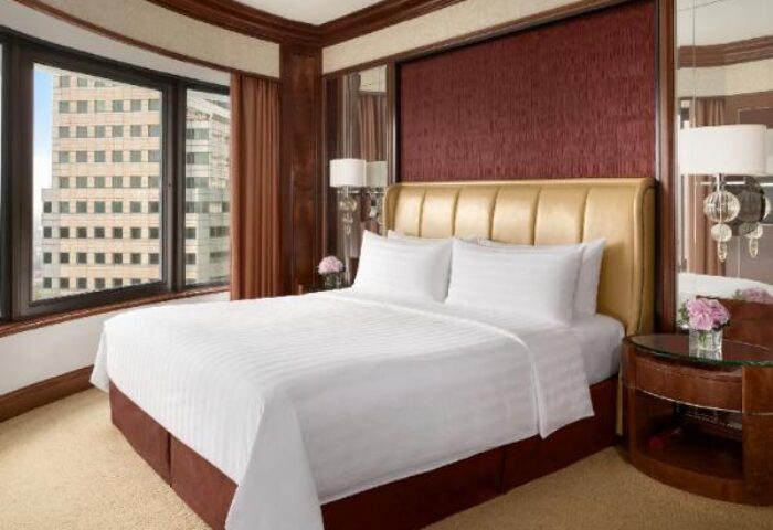 Shangri-La Hotel Kuala Lumpur room. Gay-friendly hotel with a large bed, city view, and modern decor. Perfect for gay travelers in Kuala Lumpur.