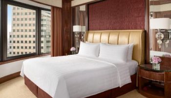 Shangri-La Hotel Kuala Lumpur room. Gay-friendly hotel with a large bed, city view, and modern decor. Perfect for gay travelers in Kuala Lumpur.