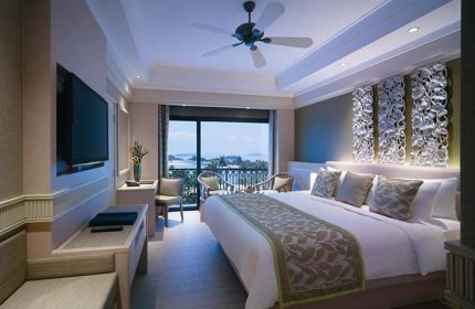Shangri-La's Rasa Sentosa Resort & Spa gay-friendly hotel room. Balcony with sea view, king bed, TV, and decorative wall art.