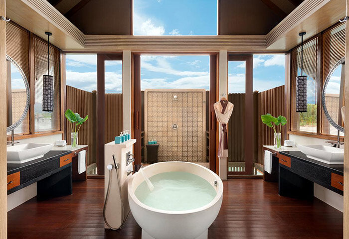 Luxury bathroom at Shangri-La's Villingili Resort & Spa, a gay-friendly hotel. Features a soaking tub, open shower, and ocean view.