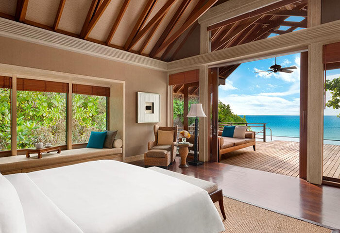 Gay-friendly Shangri-La's Villingili Resort & Spa room. Ocean view, deck, king bed. Luxury Maldives hotel for gay men's travel.