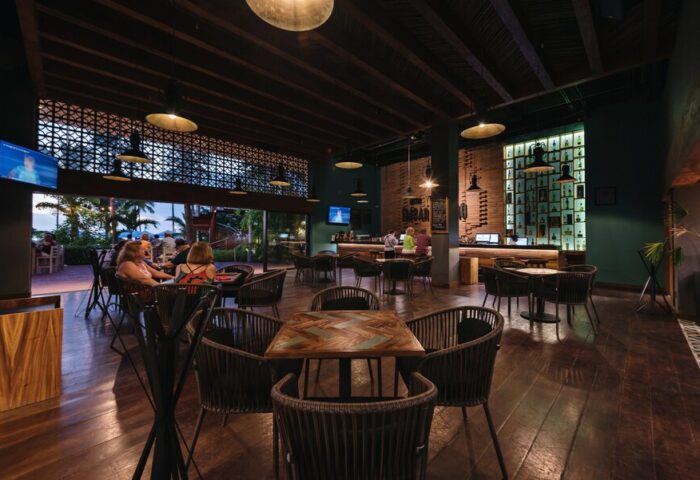 Sheraton Buganvilias Resort bar area. Gay-friendly hotel with indoor/outdoor seating, TV, and fully stocked bar. Perfect for gay travelers.
