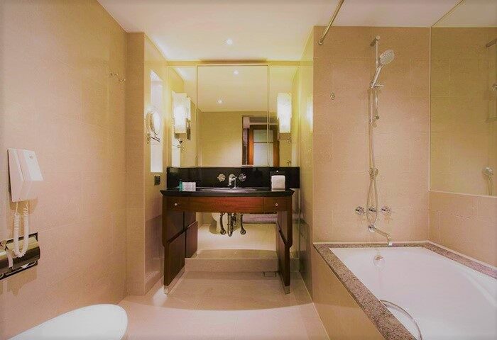 Bathroom at Sheraton Grand Taipei Hotel. Gay-friendly hotel with bathtub, shower, sink, and mirror. Upscale amenities for gay travelers in Taipei.