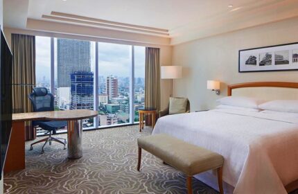 Sheraton Manila Bay gay-friendly hotel room. Desk, bed, and city view. Modern design, comfortable stay. Manila travel for gay men.