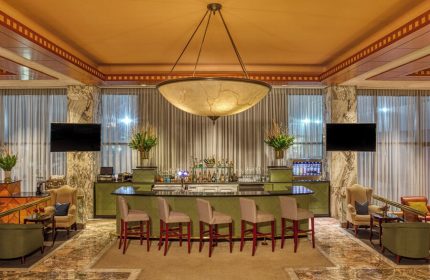 Gay-friendly Sheraton Mexico City Maria Isabel Hotel bar. Upscale bar with stools, TVs, and a large chandelier. Perfect for gay travelers in Mexico City.