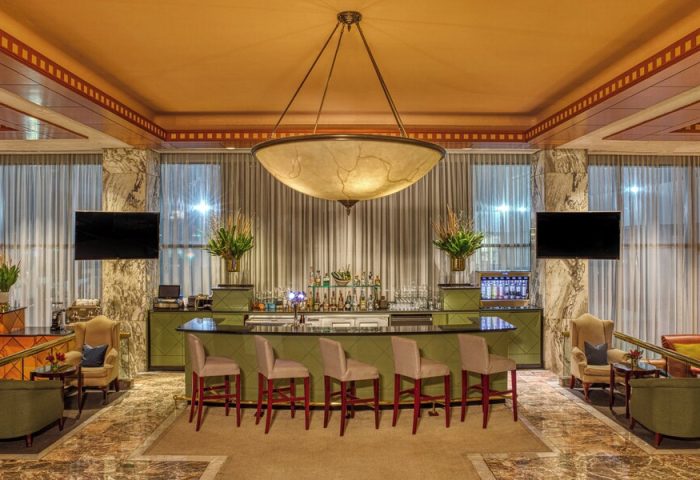 Gay-friendly Sheraton Mexico City Maria Isabel Hotel bar. Upscale bar with stools, TVs, and a large chandelier. Perfect for gay travelers in Mexico City.