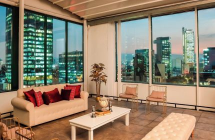 Sheraton Mexico City Maria Isabel Hotel's gay-friendly suite. Cityscape view from the suite's window. Modern design, comfortable seating.