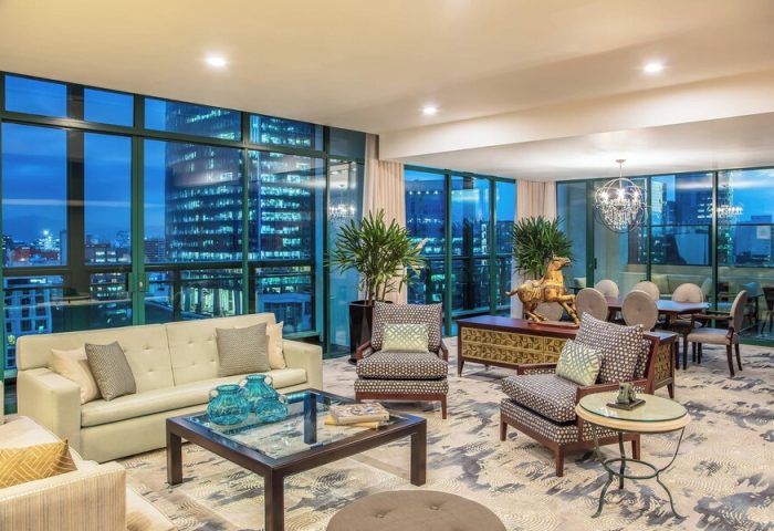 Sheraton Mexico City Maria Isabel Hotel suite. Gay-friendly hotel room with city views, sofa, chairs, table, and dining area. Upscale decor.