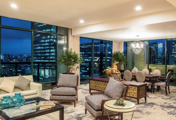Gay-Friendly Sheraton Mexico City Maria Isabel Hotel suite at night. City views, stylish furniture, and a welcoming atmosphere.