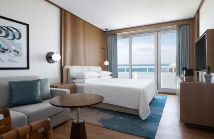 Sheraton Tel Aviv Hotel's gay-friendly room with a sea view. Pet-friendly hotel with modern decor, balcony, and comfortable furnishings.