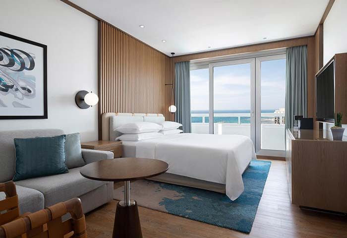 Sheraton Tel Aviv Hotel's gay-friendly room with a sea view. Pet-friendly hotel with modern decor, balcony, and comfortable furnishings.