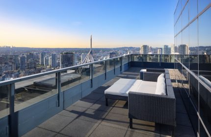 Gay-friendly Sheraton Vancouver Wall Centre hotel: Rooftop lounge area with city views. Modern outdoor furniture for relaxing in Vancouver, Canada.