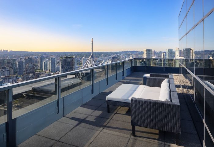 Gay-friendly Sheraton Vancouver Wall Centre hotel: Rooftop lounge area with city views. Modern outdoor furniture for relaxing in Vancouver, Canada.