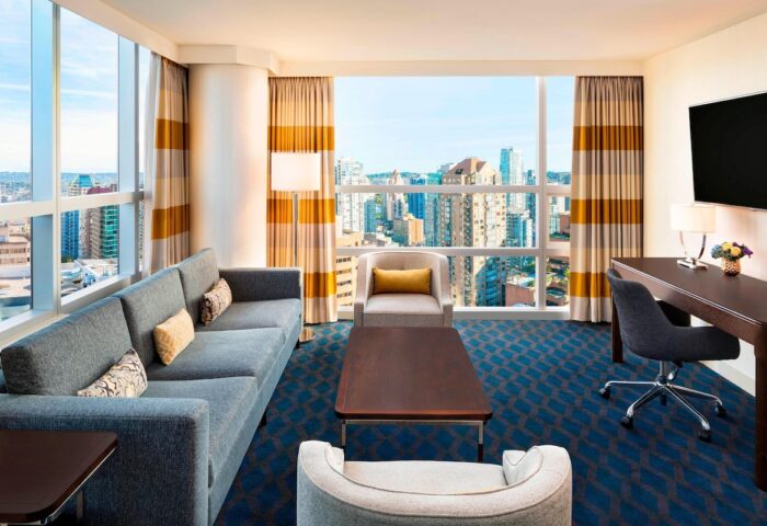 Gay-Friendly Sheraton Vancouver Wall Centre hotel room. Living area with views of Vancouver. Upscale accommodations for gay travelers.