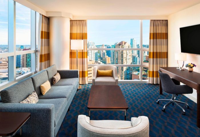 Gay-Friendly Sheraton Vancouver Wall Centre hotel room. Living area with views of Vancouver. Upscale accommodations for gay travelers.