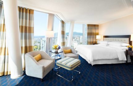 Sheraton Vancouver Wall Centre gay-friendly hotel room. Modern design, city view, comfortable seating, and a luxurious bed. Perfect for gay travel.