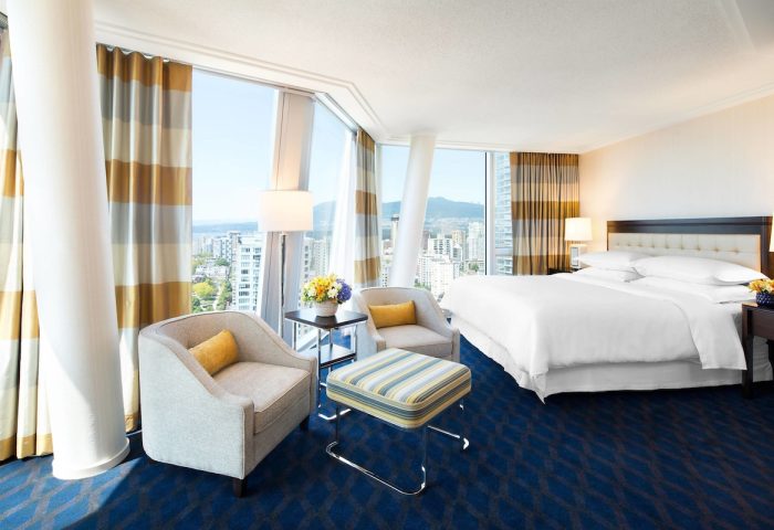 Sheraton Vancouver Wall Centre gay-friendly hotel room. Modern design, city view, comfortable seating, and a luxurious bed. Perfect for gay travel.
