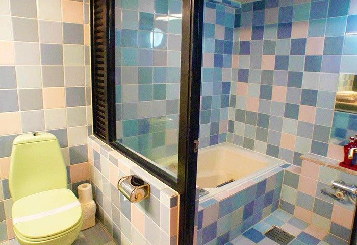 Bathroom at Shinjuku City Hotel N.U.T.S Tokyo. This gay-friendly hotel features colorful tilework and a bathtub. Ideal for gay travelers.