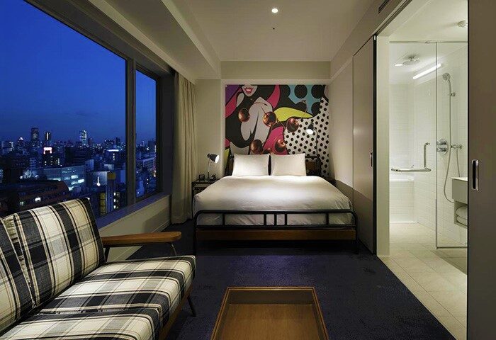 Shinjuku Granbell Hotel room. Gay-friendly hotel with city view, bed with colorful art, and modern bathroom. Tokyo hotel for gay travelers.
