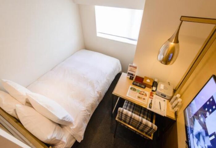 Single room at Shinjuku Granbell Hotel, a gay-friendly hotel. Features a bed, desk, TV, and window. Perfect for solo gay travelers in Tokyo.