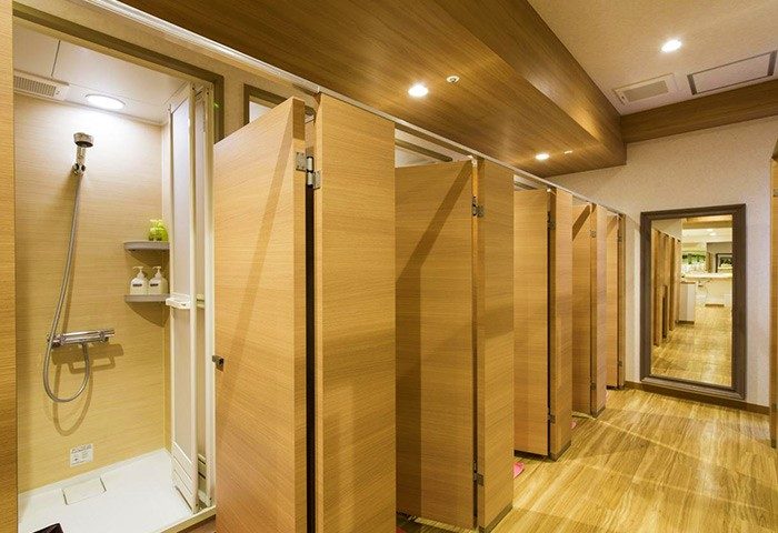 Shinjuku Kuyakusho-mae Capsule Hotel shower rooms. Gay-friendly hotel with private shower booths. Clean, modern design for gay travelers.
