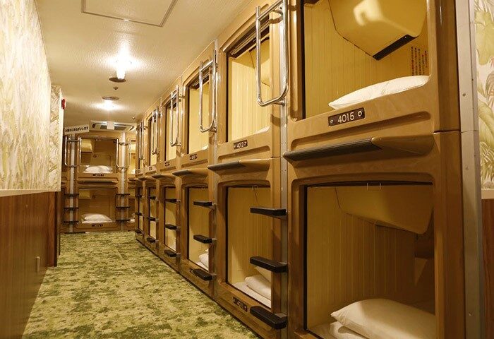 Interior of Shinjuku Kuyakusho-mae Capsule Hotel, a gay-friendly hotel. Rows of sleeping capsules, offering a unique, budget-friendly stay.