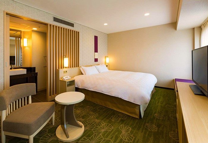 Shinjuku Prince Hotel room. Gay-friendly hotel with a bed, chair, table, TV, and bathroom. Ideal for gay men traveling in Shinjuku, Japan.