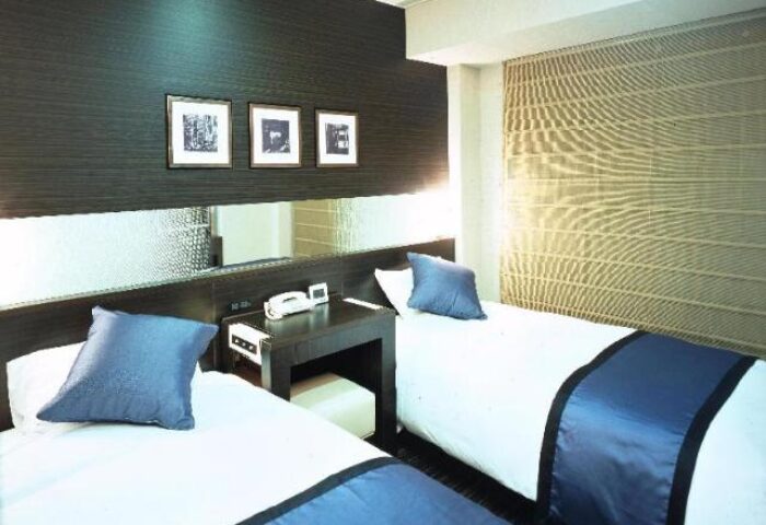 Shinjuku Prince Hotel twin room. Gay-friendly hotel in Shinjuku, Tokyo. Modern decor, two beds with blue accents. Ideal for gay travel.