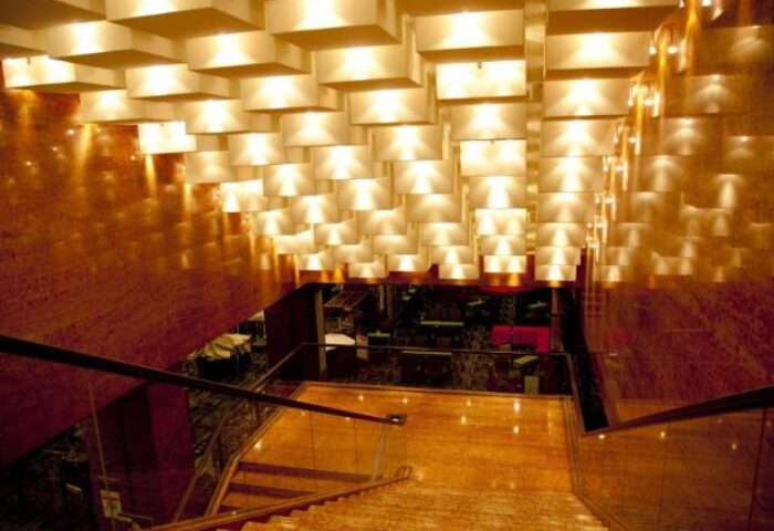 Staircase at Shinjuku Prince Hotel, a gay-friendly hotel. Modern lighting fixtures illuminate the steps. Interior design for gay travelers in Tokyo.