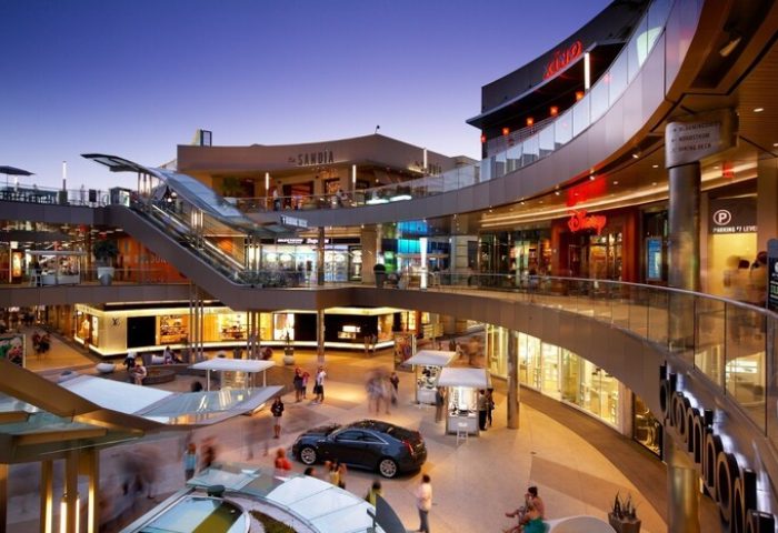 Shopping mall near Shore Hotel, a gay-friendly hotel. Multi-level retail space with escalators, shops, and restaurants. Modern architecture and bustling atmosphere.