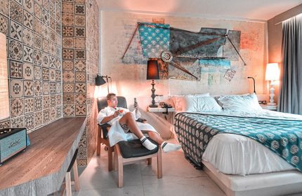 Gay man relaxing in Siam @ Siam Design Hotel Bangkok room. Modern decor, stylish design. Gay-friendly hotel for LGBT travelers.